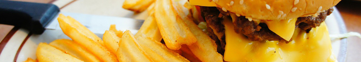 Eating Burger Chicken Wing Pub Food at Britt's Bar & Grill restaurant in Louise, TX.